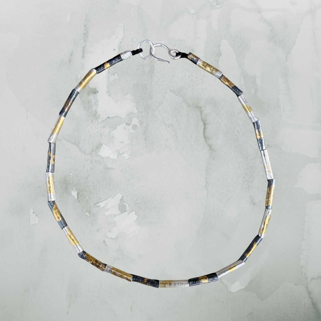 Wrapped beaded necklace in fine silver with Keum-Boo gold detail by HerbertandWilks on soft green background