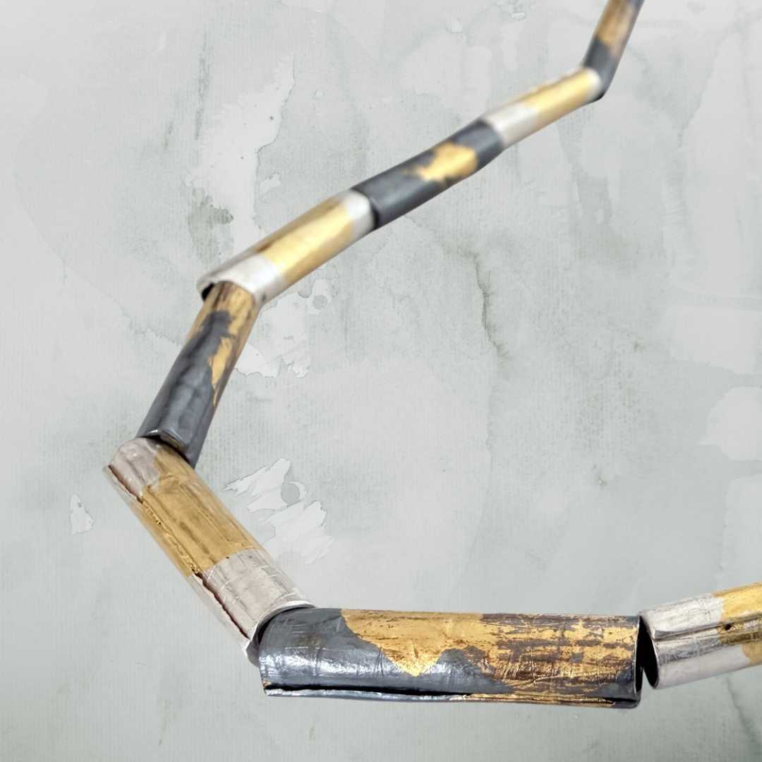 Detail of wrapped fine silver beads with Keum-Boo gold surface, showing hand-applied texture