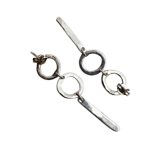 Back view of the Abstract Circle Earrings No. 25 in sterling silver lying face-down on a white background to show stud fittings and polished backs.