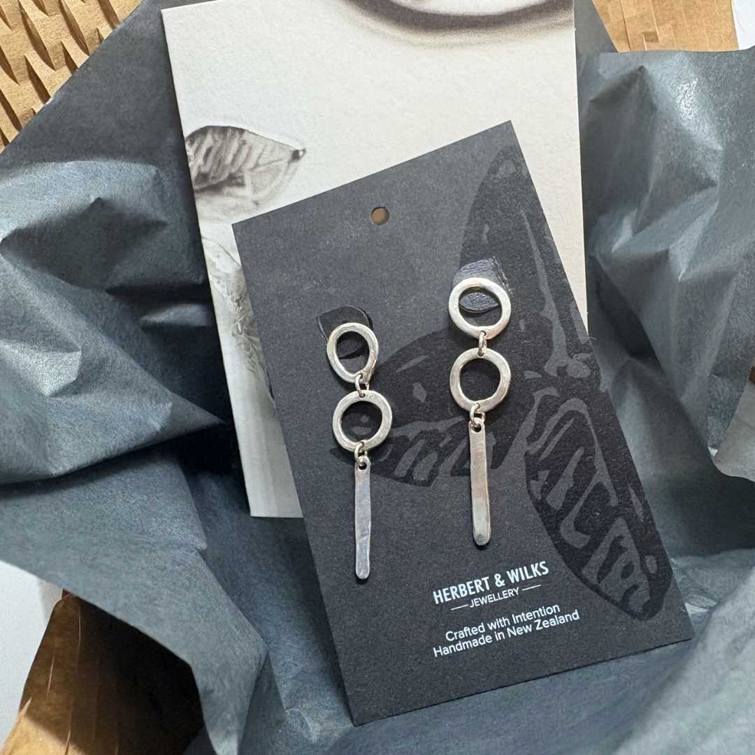 Abstract Circle Earrings No. 25 in sterling silver displayed on a HerbertandWilks packaging card with black tissue