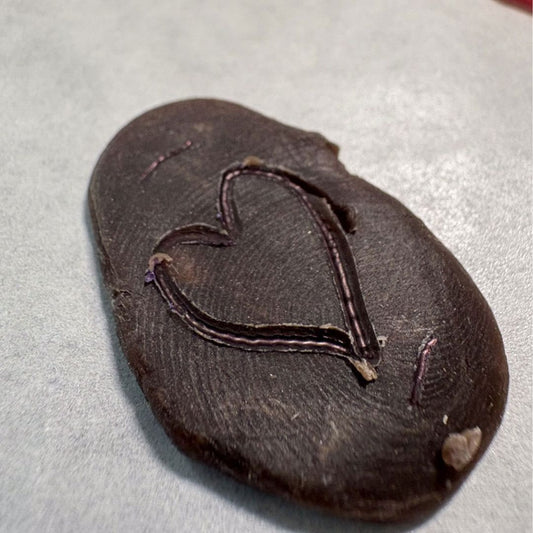 Wax disc with fingerprint texture and hand-drawn heart for charm making workshop - you could choose any shape to draw