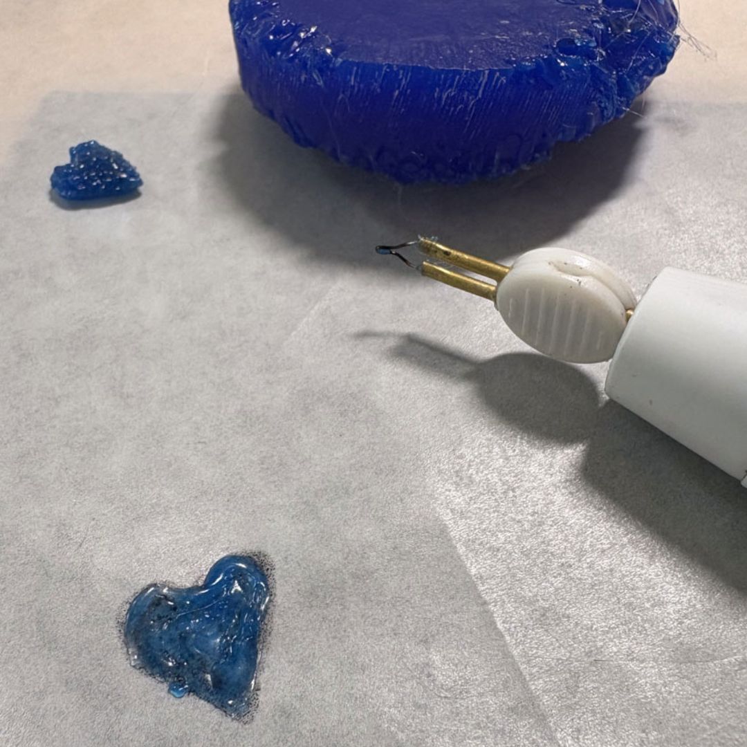 Wax build-up process showing wax pen, partially completed charms and wax block