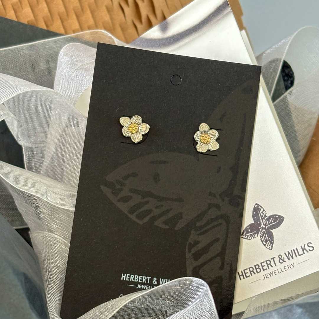Daisy Stud Earrings displayed on HerbertandWilks Jewellery card, ready for packing with soft tissue and organza ribbon, silver and gold flower detail visible.
