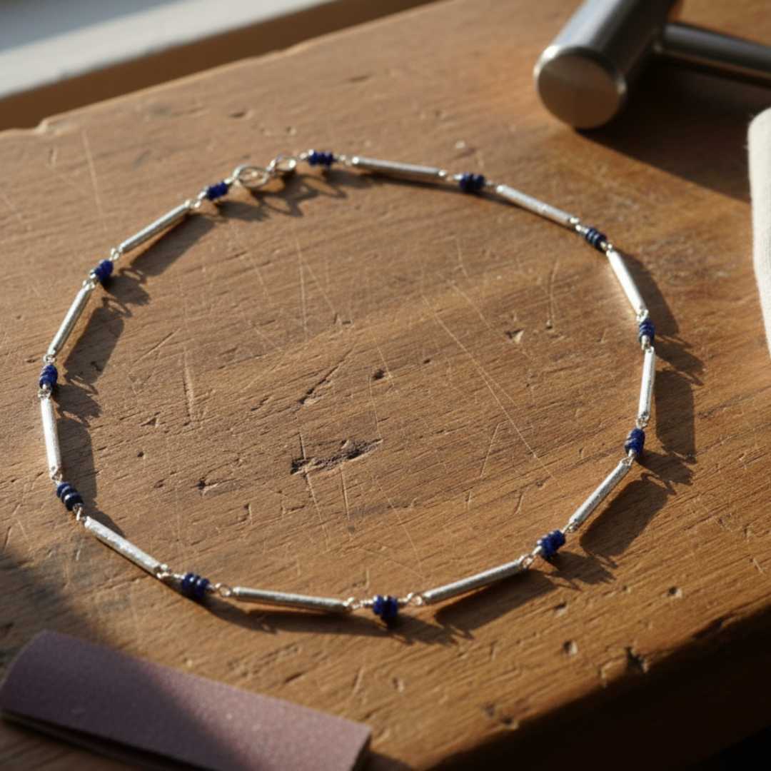 Sterling silver chain necklace with blue sapphires on jeweller's workbench in Auckland studio - handcrafted by Sally Herbert of HerbertandWilks