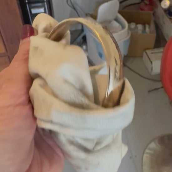 Handcrafted bronze bangle being polished in Auckland workshop - artisan jewellery making process