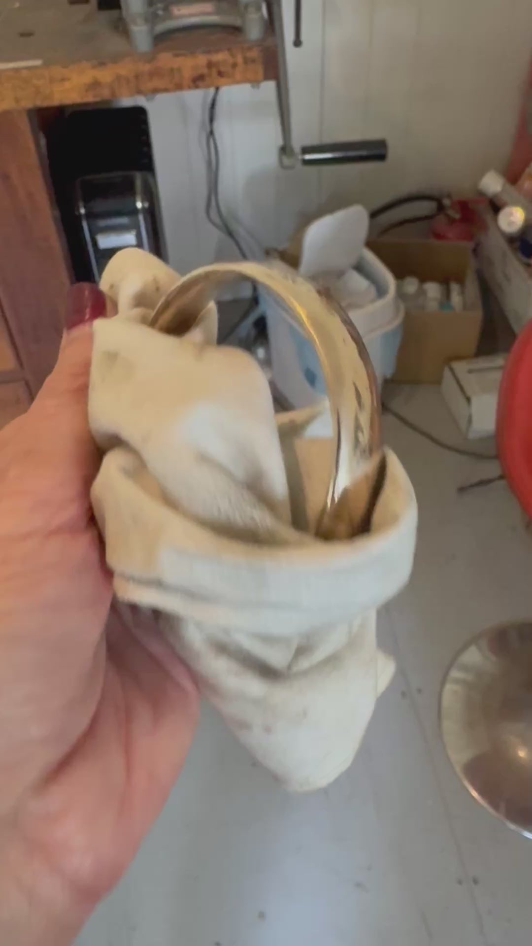 Handcrafted bronze bangle being polished in Auckland workshop - artisan jewellery making process