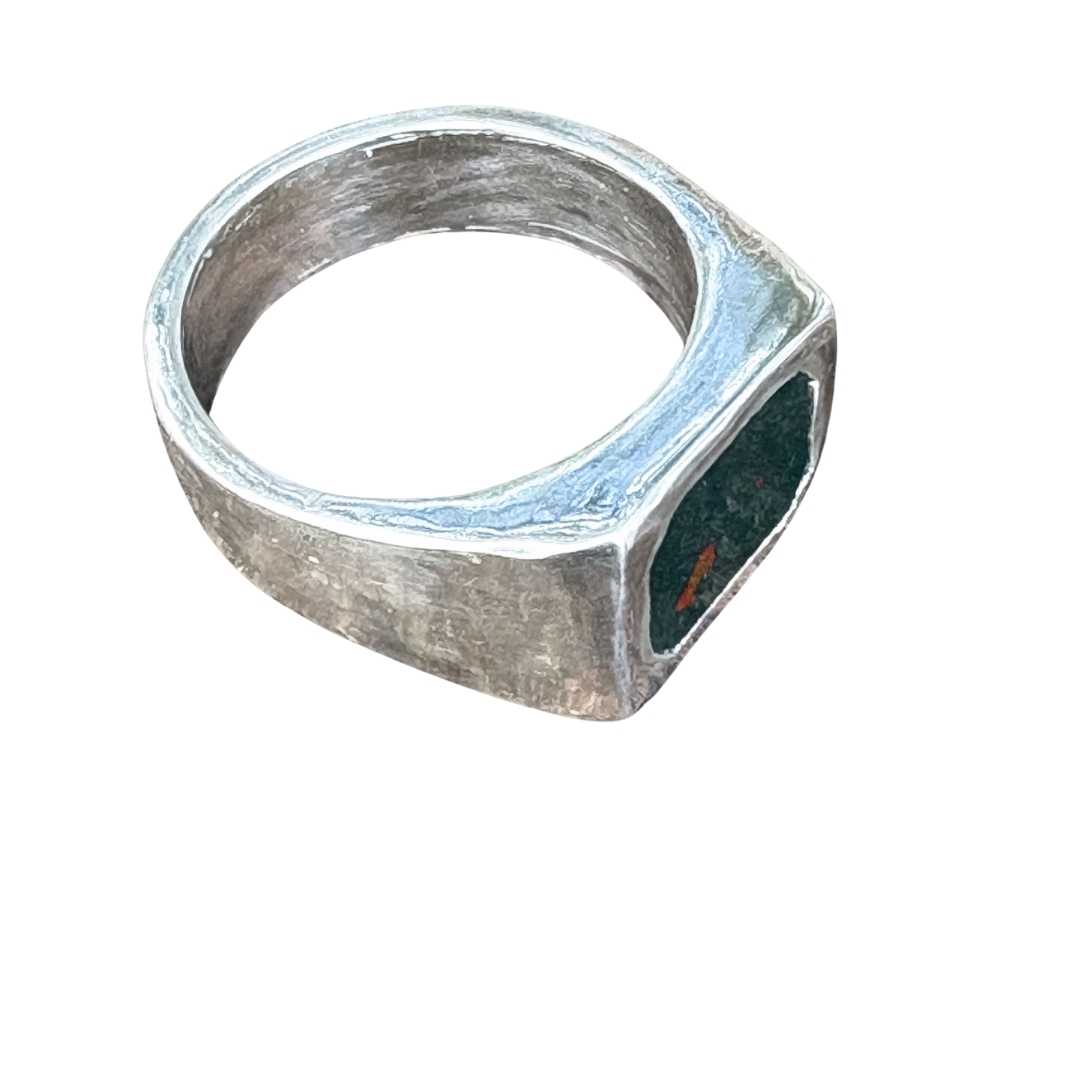 Top view of Rectangle Bloodstone Signet Ring against white background, showing the deep green Bloodstone with red flecks and soft-polished silver surface.