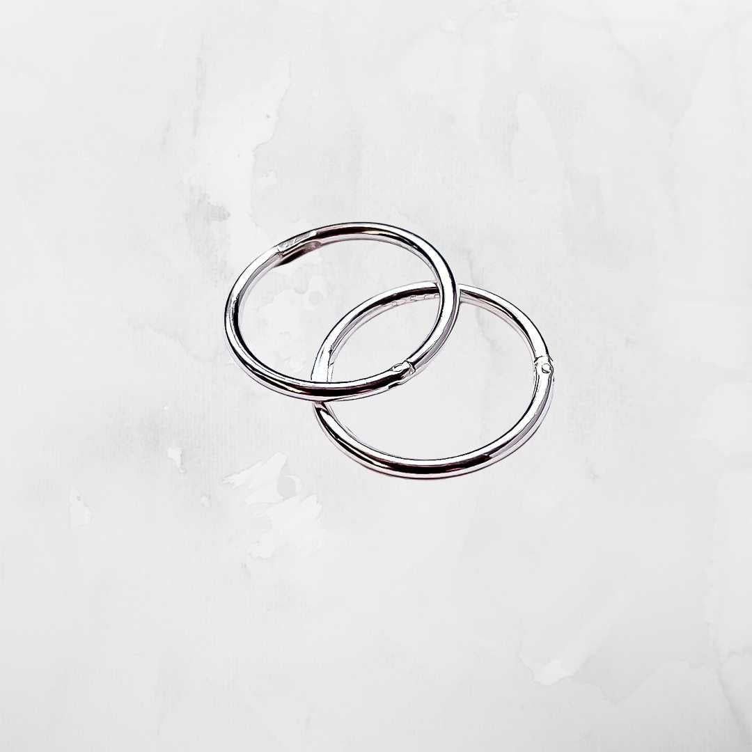 Sterling silver sleeper earrings on light grey background - comfortable everyday hoops New Zealand