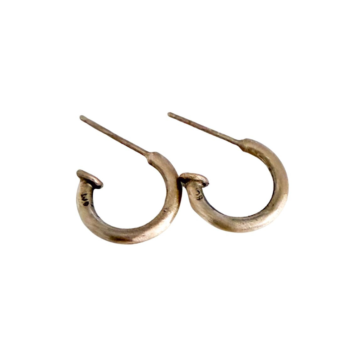 A pair of small, open 9ct gold hoop earrings in a textured finish, shown against a plain white background.