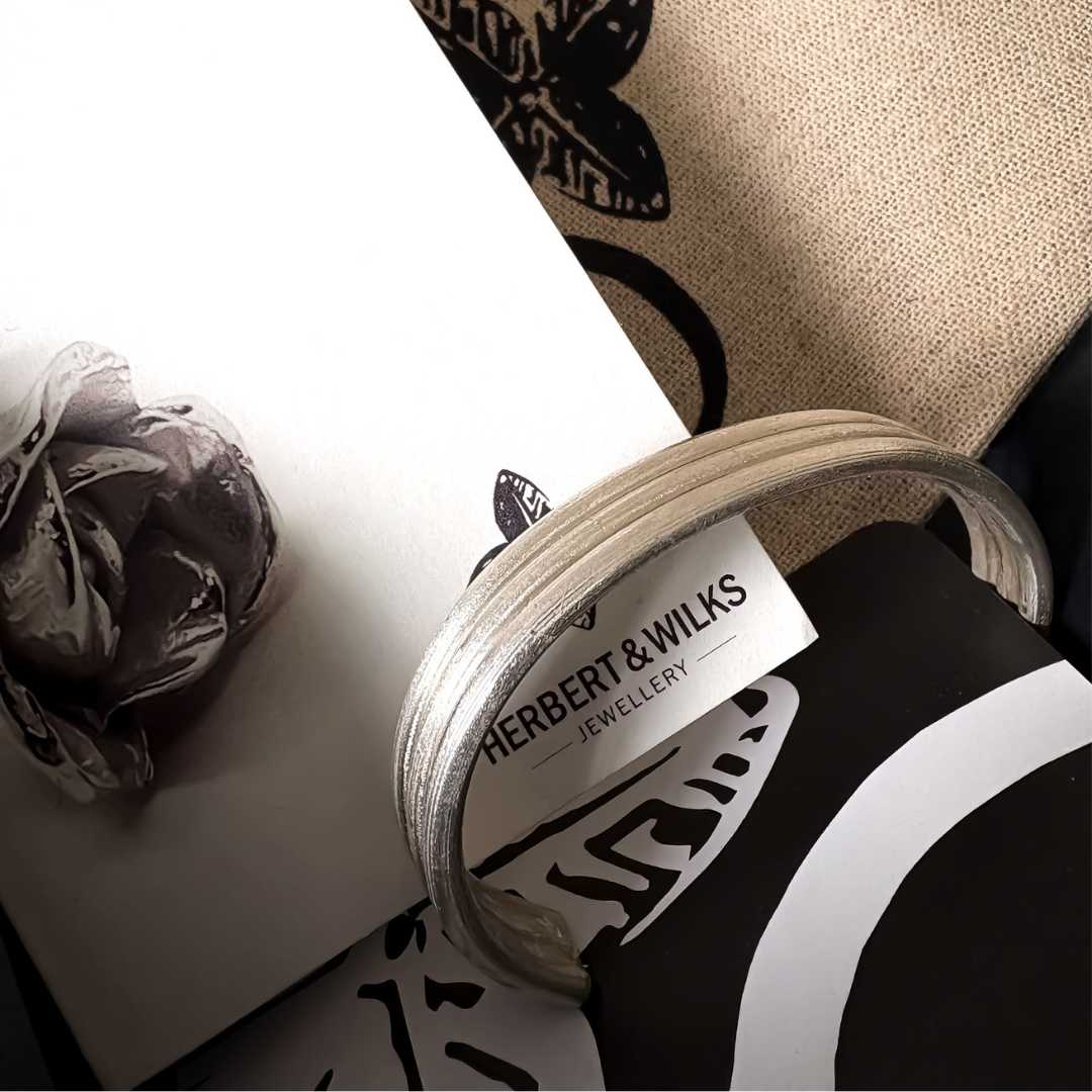 Three Line Cuff in sterling silver presented in HerbertandWilks gift packaging.