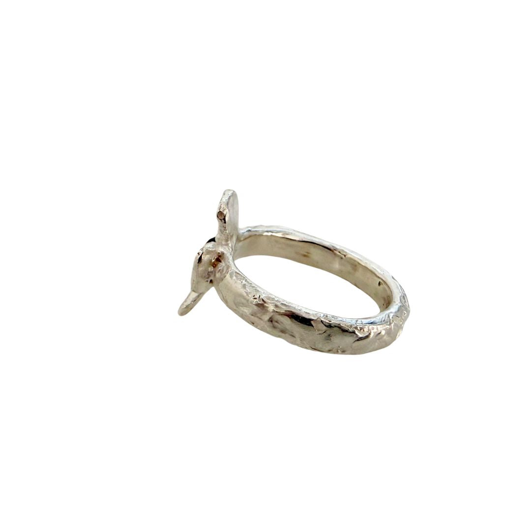 Side and back view of Waiatarua Narrow sterling silver flower ring showing the textured handmade band and flower profile.
