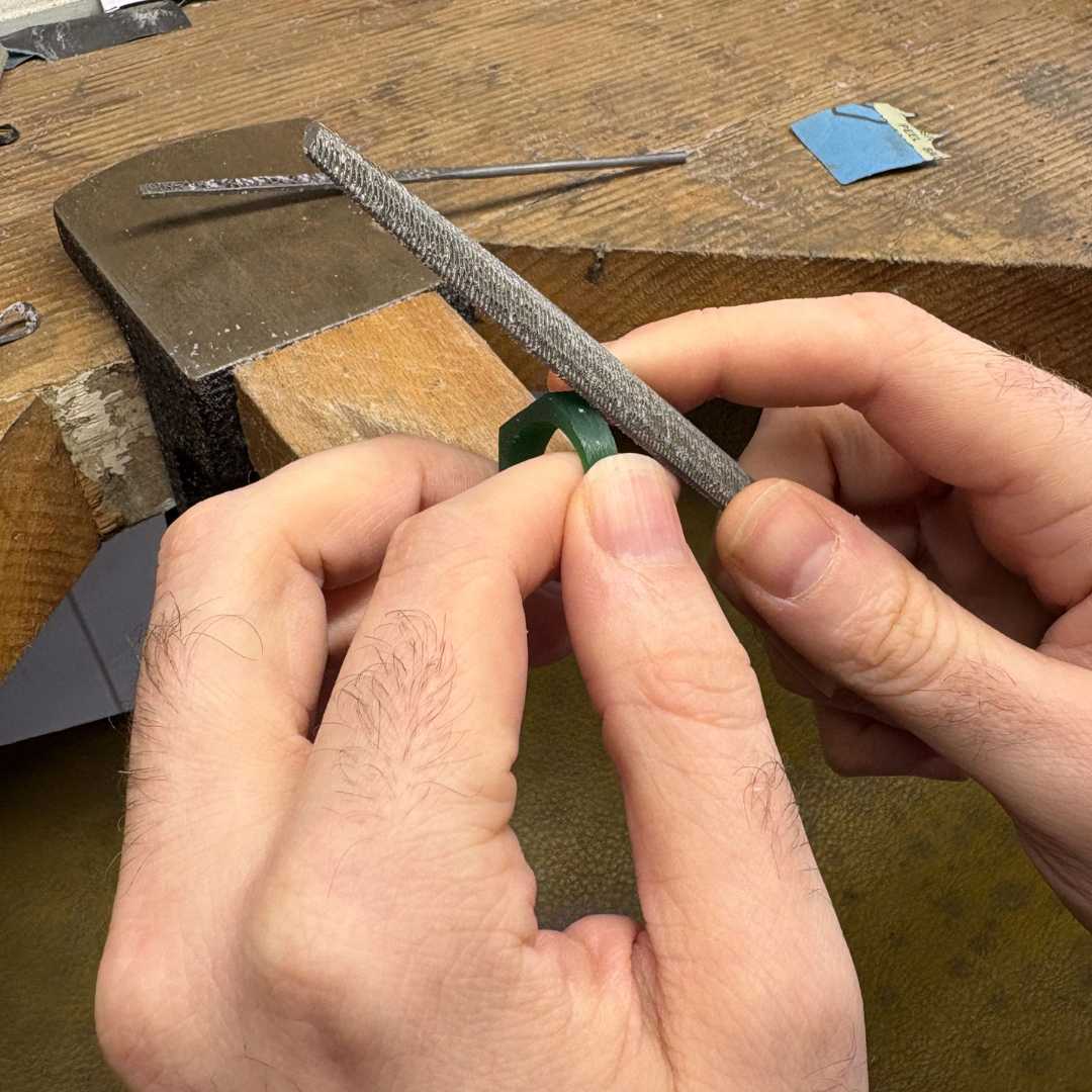 Filing a green wax signet ring prototype during a lost wax carving workshop in Auckland.