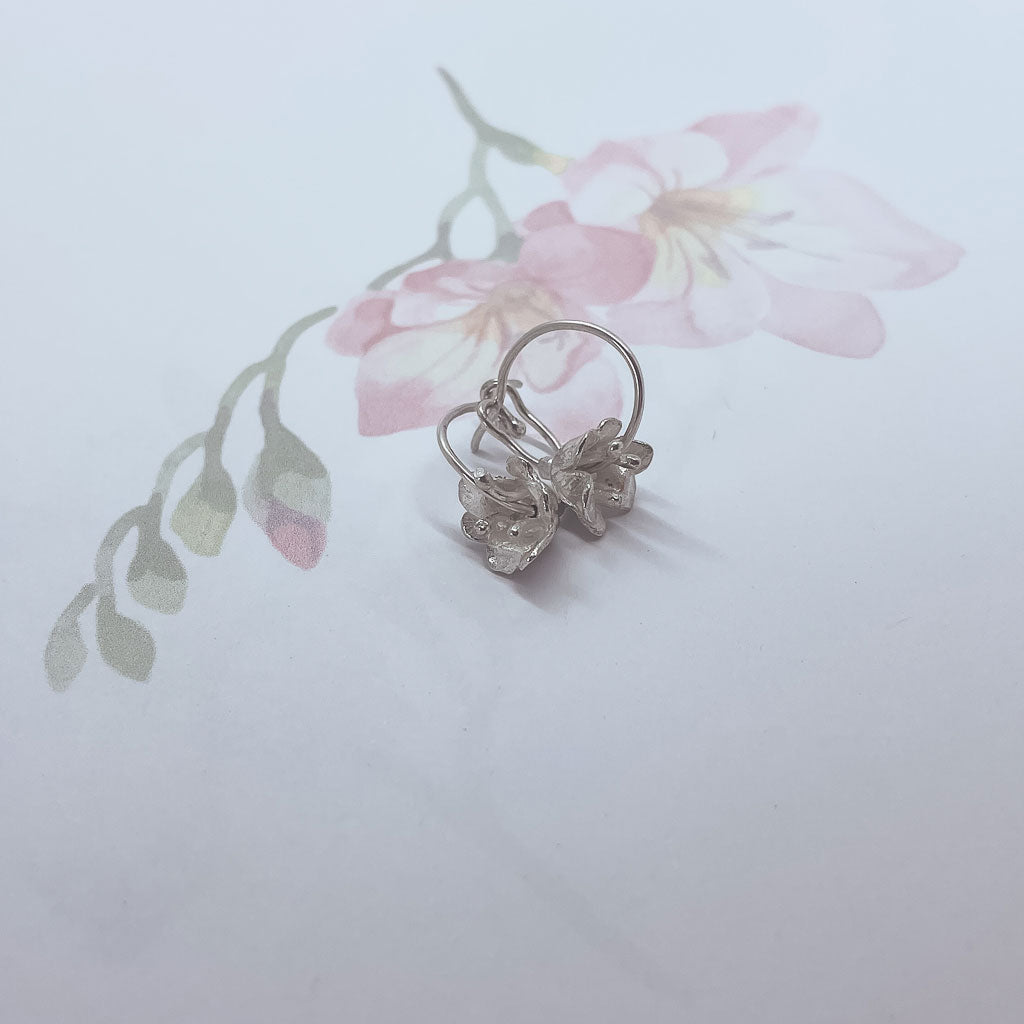 A pair of delicate 3D Sterling Silver freesia Flower Hoop Earrings