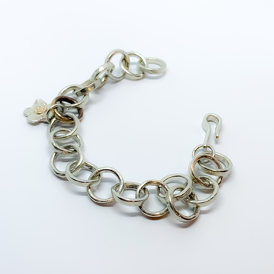 Silver and Bronze medium weight link bracelet with a Silver and 18ct Recycled Gold centre daisy charm