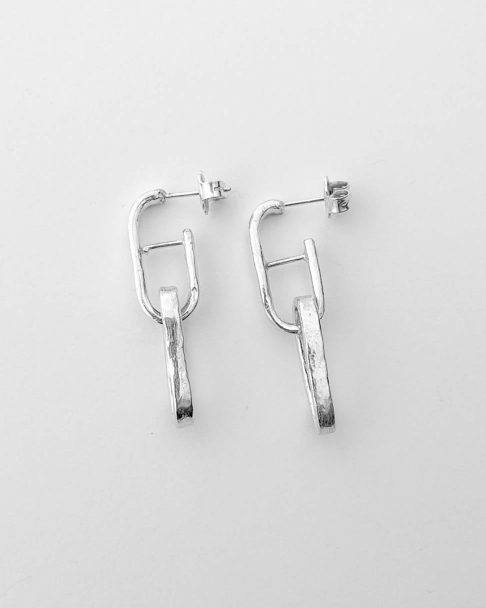 A pair of Long link chain earrings in sterling silver showing the side profile
