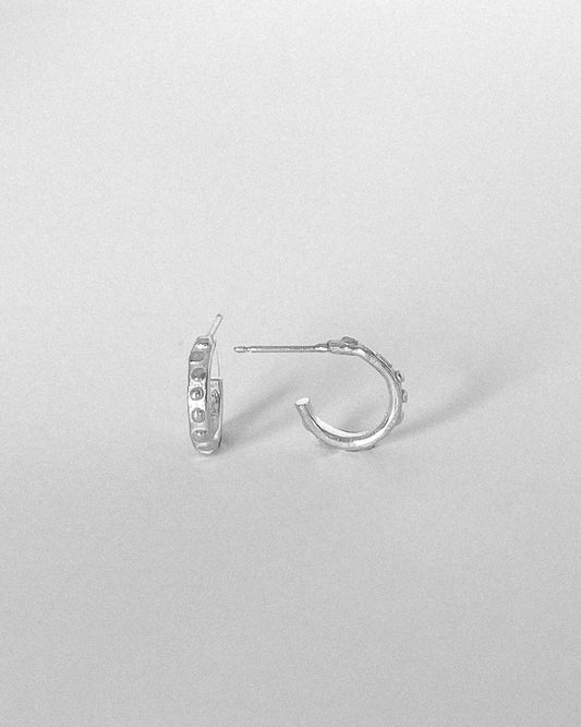 A pair of Hoop Earrings showing front and side profile in Sterling Silver