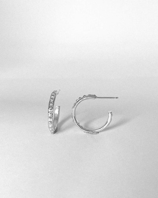 A pair of Textured Hoop Earrings showing front and side profile in Sterling Silver