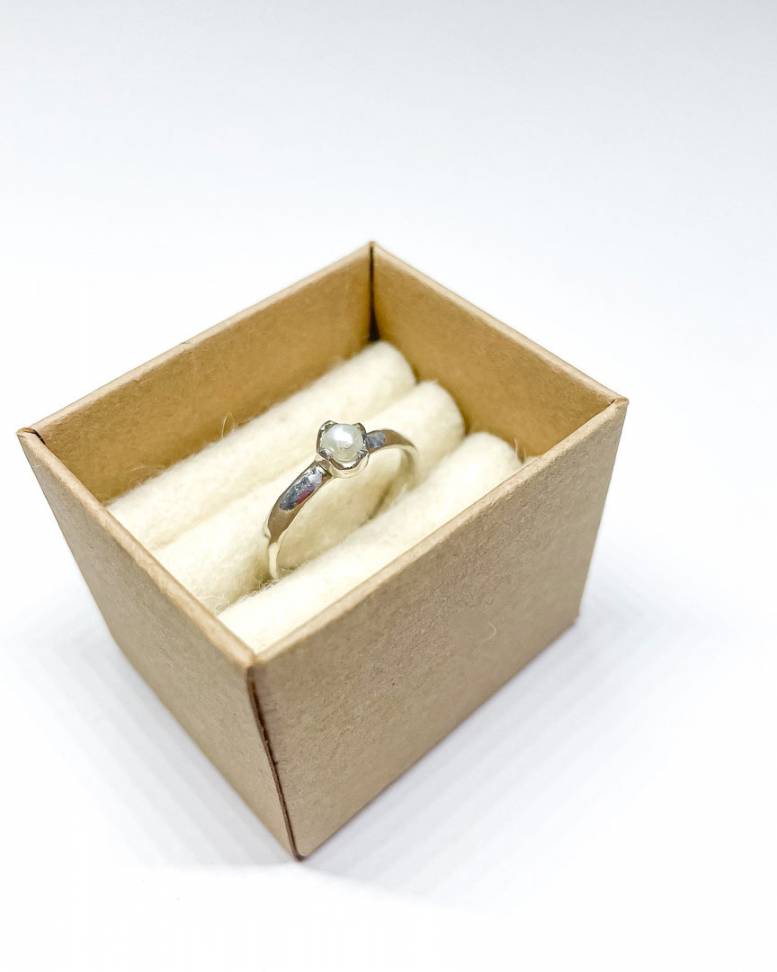 A delicate sterling Silver Freshwater White Pearl Stacking Ring sitting in a ring box