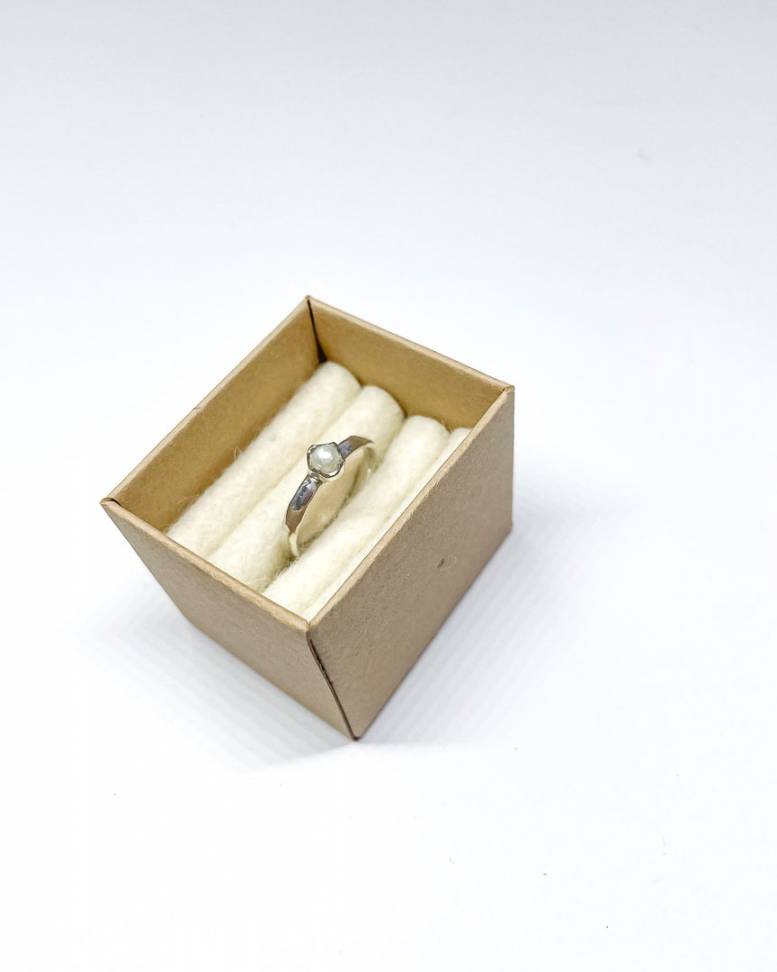 A delicate sterling Silver Freshwater White Pearl Stacking Ring sitting in a ring box