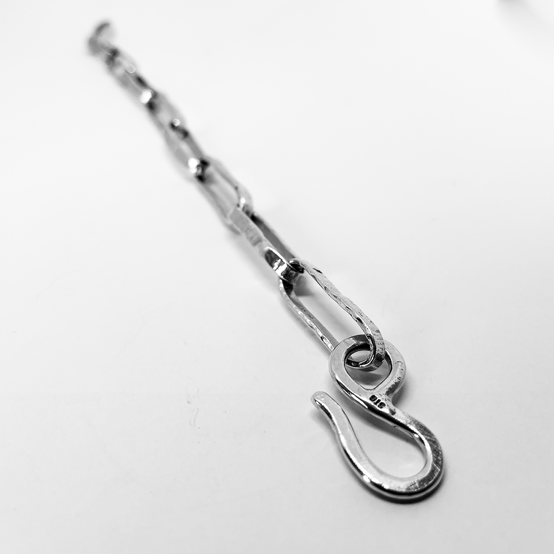 Profile of the Oval Link Chain Bracelet focusing on the clasp