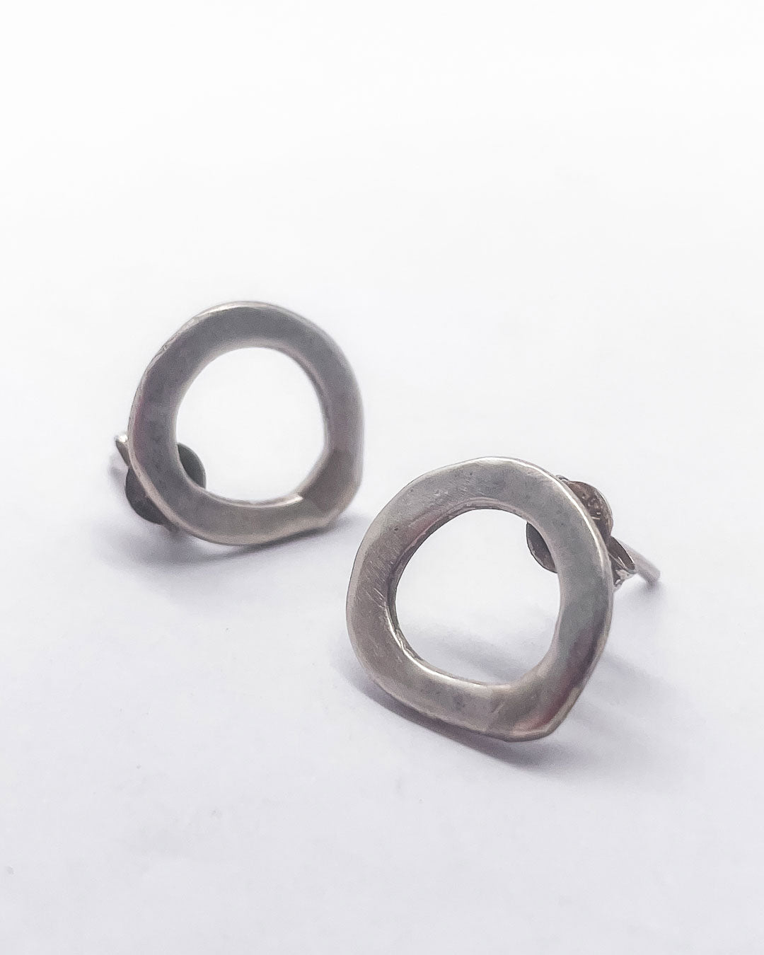 A Pair of beautifully elegant and lightweight stud earrings formed from single abstract circles in Sterling Silver